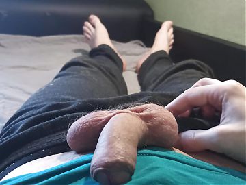 Guy in blue t-shirt jerking off his cock lying on the bed